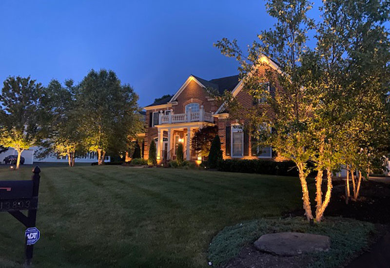 nice house and trees outdoor lighting