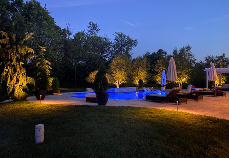 trees, nice pool and outdoor lighting at night